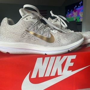 Women’s gold Nike zoom